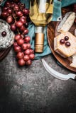 Bottle of wine with fine cheese and grape on dark rustic background, top view royalty free stock photos Bottle of wine with fine cheese and grape on dark rustic background, top view royalty free stock photos