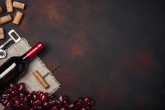 Bottle of wine, red grapes, corkscrew and corks, on rusty background top view royalty free stock photos Bottle of wine, red grapes, corkscrew and corks, on rusty background top view royalty free stock photos