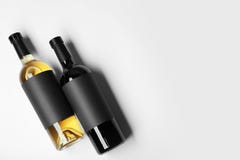 Bottles of wine with blank labels on light background. stock image Bottles of wine with blank labels on light background. stock image