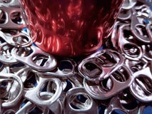 Bottom Part of Red Beverage Can on Pile of Tabs Royalty Free Stock Image Bottom Part of Red Beverage Can on Pile of Tabs Royalty Free Stock Image