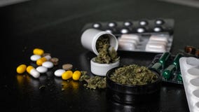 Botões médicos da marijuana em cada kit de primeiros socorros os comprimidos e os cannabis encontram-se em um fundo preto Os cuid imagens de stock royalty free Botões médicos da marijuana em cada kit de primeiros socorros os comprimidos e os cannabis encontram-se em um fundo preto Os cuid imagens de stock royalty free
