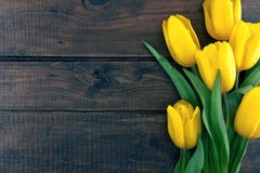 Bouquet Of Yellow Tulips On Dark Rustic Wooden Background Bouquet Of Yellow Tulips On Dark Rustic Wooden Background