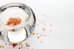 Bowl with gold beads on light background closeup stock photo Bowl with gold beads on light background closeup stock photo
