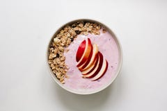 Bowl of oatmeal porridge with blueberry yoghurt, milk and muesli with an apple on concrete background. Organic healthy royalty free stock photography Bowl of oatmeal porridge with blueberry yoghurt, milk and muesli with an apple on concrete background. Organic healthy royalty free stock photography
