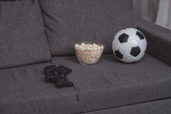 bowl with popcorn, football ball and gamepads royalty free stock photo bowl with popcorn, football ball and gamepads royalty free stock photo