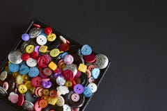 Box with multicolored buttons on black background stock photography Box with multicolored buttons on black background stock photography