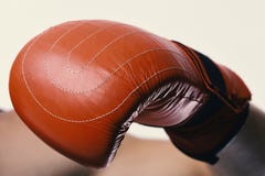 Boxer demonstrates red leather glove in close up. Athlete with box equipment isolated on white background Stock Photos Boxer demonstrates red leather glove in close up. Athlete with box equipment isolated on white background Stock Photos