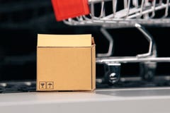 Boxes in and trolley on a laptop online shopping is a form of electronic commerce that allows consumers to directly buy stock photos Boxes in and trolley on a laptop online shopping is a form of electronic commerce that allows consumers to directly buy stock photos
