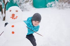 Boy And A Snowman - Winter Holiday Stock Photography