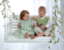 Boy And Girl On Swing With Bunny Royalty Free Stock Photography