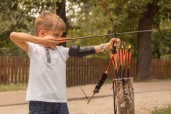 Boy with a bow and arrow. Children and sports. Archery background. Junior Archery school.