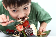Boy Eating Cheesecake Royalty Free Stock Photography Boy Eating Cheesecake Royalty Free Stock Photography