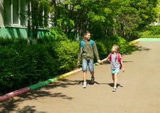 A boy and a girl brother and sister go to school with school bags. Horizontal frame. Selective focus. Copy space. royalty free stock photography A boy and a girl brother and sister go to school with school bags. Horizontal frame. Selective focus. Copy space. royalty free stock photography