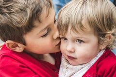 A boy and a girl, brothers, kissing each other. royalty free stock photos A boy and a girl, brothers, kissing each other. royalty free stock photos