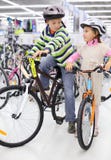 Boy and girl in helmets sit on bright bicycles royalty free stock photos Boy and girl in helmets sit on bright bicycles royalty free stock photos