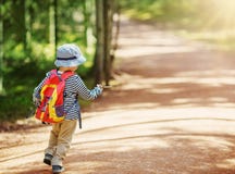 Boy going camping with backpack in nature stock image Boy going camping with backpack in nature stock image