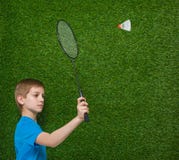 Boy holding badminton racket flying shuttlecock Royalty Free Stock Photography Boy holding badminton racket flying shuttlecock Royalty Free Stock Photography
