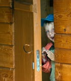 Boy In A Wooden House. Royalty Free Stock Photography