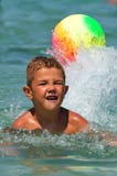 Boy In The Water Playing With A Ball Stock Image