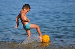 Boy In The Water Playing With A Ball Stock Photography