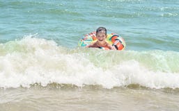 Boy in inflatable ring floating on the sea all wet and happy, Stock Photography Boy in inflatable ring floating on the sea all wet and happy, Stock Photography