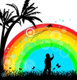 Boy with kite under rainbow