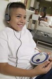 Boy Listening To Music On Portable CD Player In Living Room Stock Photos Boy Listening To Music On Portable CD Player In Living Room Stock Photos