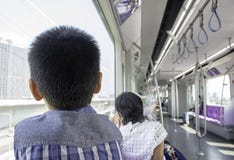 The boy looked at the scenery outside the train window in city royalty free stock photo The boy looked at the scenery outside the train window in city royalty free stock photo