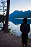 Boy Looking at Mountain Lake