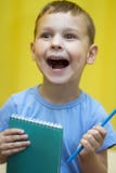 The boy with the notebook is happy royalty free stock photo The boy with the notebook is happy royalty free stock photo