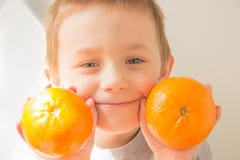 Boy with oranges in his hands royalty free stock photo Boy with oranges in his hands royalty free stock photo