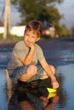 Boy play with autumn paper ship in water, chidren in park play w royalty free stock photo Boy play with autumn paper ship in water, chidren in park play w royalty free stock photo