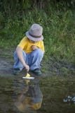 Boy play with autumn paper ship in water, chidren in park play w Stock Photos Boy play with autumn paper ship in water, chidren in park play w Stock Photos