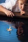 Boy play with leaf ship in water royalty free stock photos Boy play with leaf ship in water royalty free stock photos
