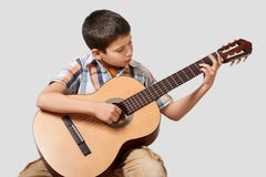 Boy is playing the acoustic guitar Stock Image Boy is playing the acoustic guitar Stock Image