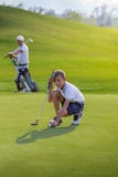Boy playing golf, makigng shot on the green stock photos Boy playing golf, makigng shot on the green stock photos