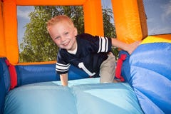 Boy playing on and inflatable Slide