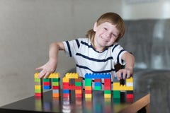 Boy playing with lots of colorful plastic blocks indoor royalty free stock image Boy playing with lots of colorful plastic blocks indoor royalty free stock image