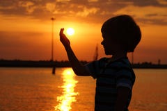 Boy by the sea at sunset royalty free stock photos Boy by the sea at sunset royalty free stock photos