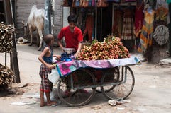 Boy selling litchi fruit at street of New Delhi