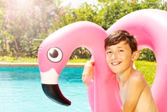 Boy with swim ring at the edge of swimming pool stock image Boy with swim ring at the edge of swimming pool stock image