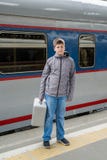 Boy teen with a travel bag near train stock images Boy teen with a travel bag near train stock images