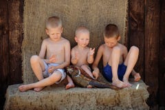 The boy tells the brothers about the successes in fishing stock images The boy tells the brothers about the successes in fishing stock images