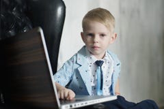 Boy using a laptop. Image cross processed for darker effect royalty free stock photos Boy using a laptop. Image cross processed for darker effect royalty free stock photos