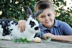 Boy With A Rabbit In The Garden Stock Photos Boy With A Rabbit In The Garden Stock Photos