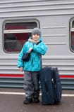 Boy With A Travel Bag Near A Train Royalty Free Stock Images