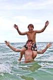Boys Having Fun In The Beautiful Clear Sea Royalty Free Stock Photos