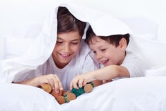 Boys playing in bed with wooden toys royalty free stock image Boys playing in bed with wooden toys royalty free stock image