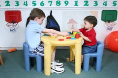 Boys Sharing Colorful Doah At Preschool Royalty Free Stock Image