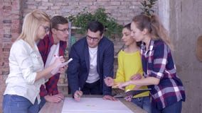 Brainstorming in modern office, successful working team discussing on development project of new business ideas on big stock video Brainstorming in modern office, successful working team discussing on development project of new business ideas on big stock video